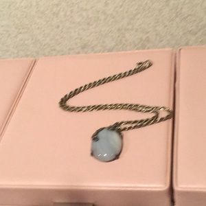 Necklace with natural moon stone pendant on chain.
